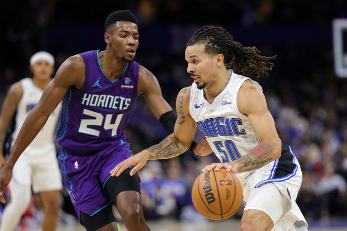 Orlando Magic guard Cole Anthony (50) drives past Charlotte Hornets forward Brandon Miller (24) in the team's win on Sunday